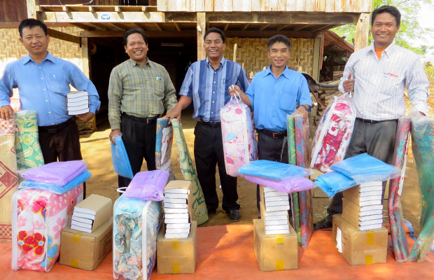Men receiving Village Outreach Kits