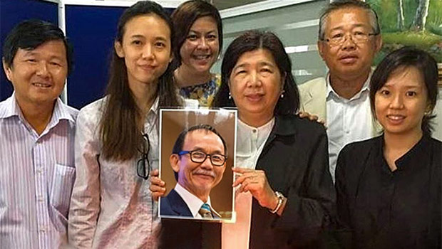 Family members holding picture of Pastor Raymond Koh