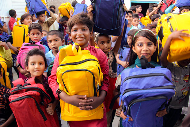 Children holding Christmas Care Packs