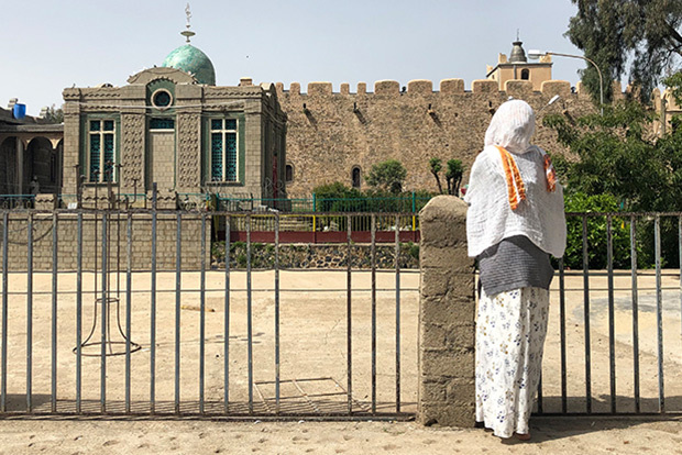 Woman standing in front of church